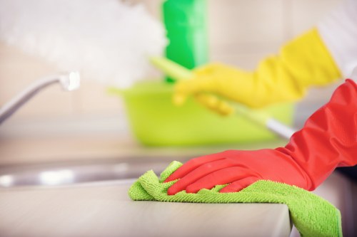 Office cleaning team sanitizing desks and shared workspaces